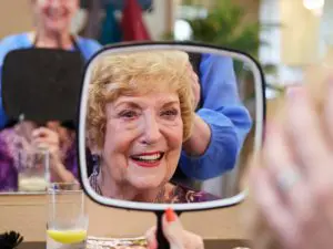 CC_amenities Independent senior living in Escondido, CA woman looking at mirror at Cypress Court